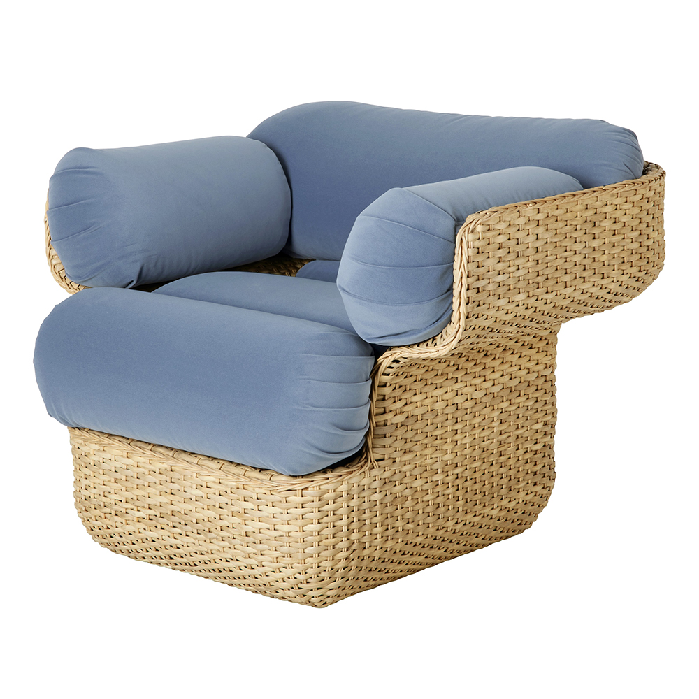 The GUBI Basket Chair has a steel skeleton for strength and stability that is wrapped in a hand-woven rattan skin. Supportive seat and back cushions and cylindrical bolsters provide comfort. 